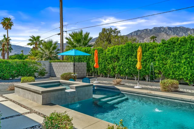 a view of a house with sitting area and garden