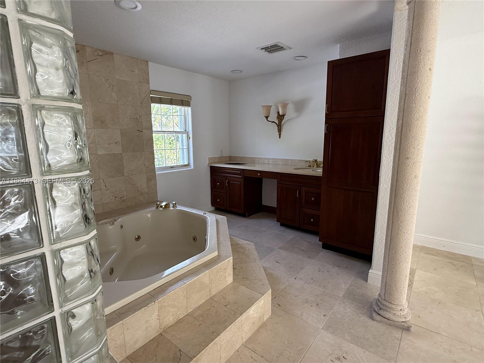15051 Southwest 149th Street Miami, FL 33196 - Photo 17 of 20 a bathroom with a tub sink and mirror