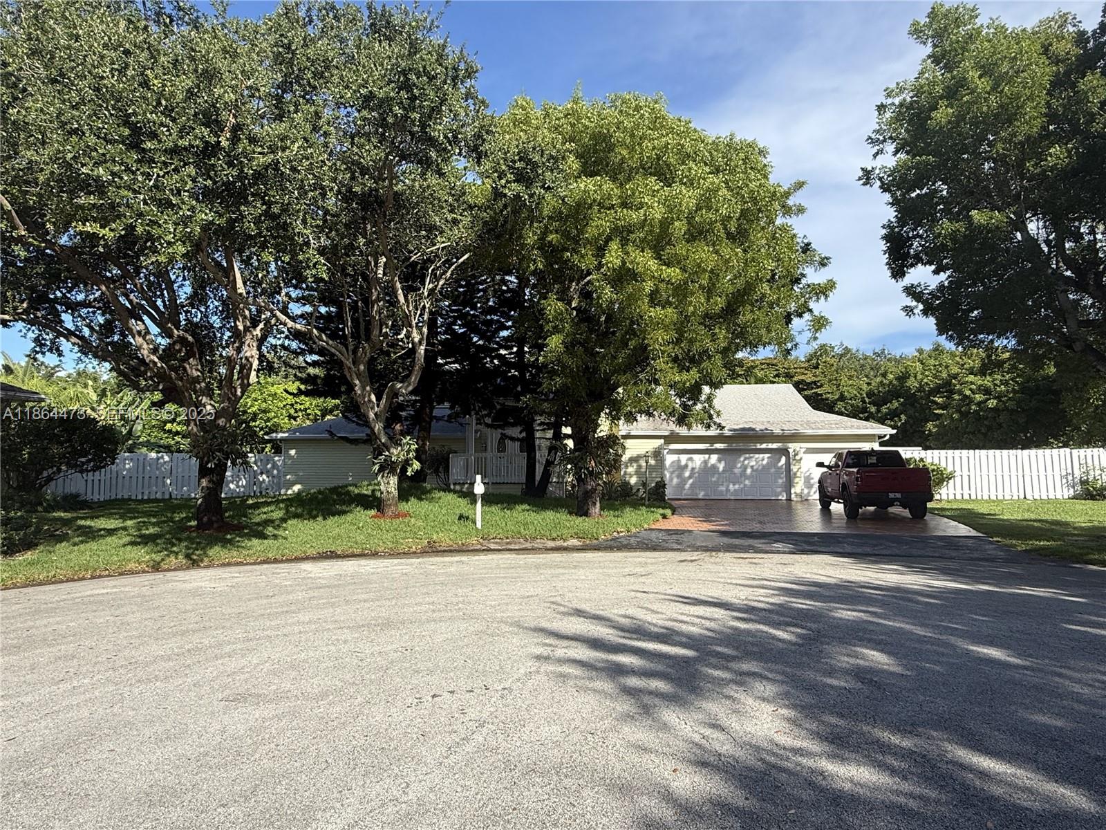15051 Southwest 149th Street Miami, FL 33196 - Photo 3 of 20 a house with trees in the background
