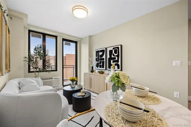 a living room with furniture and floor to ceiling window