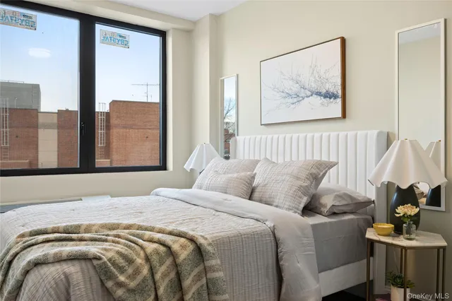 a bedroom with a bed and glass windows