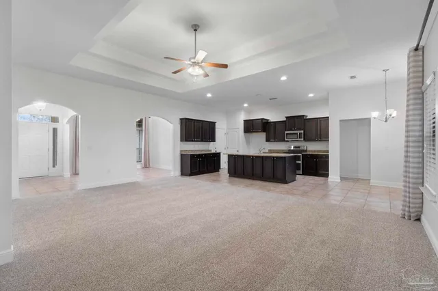 a view of kitchen with stainless steel appliances kitchen island microwave and stove