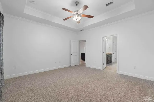an empty room with closet and a ceiling fan