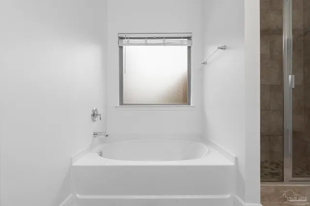 a white bath tub sitting next to a white sink