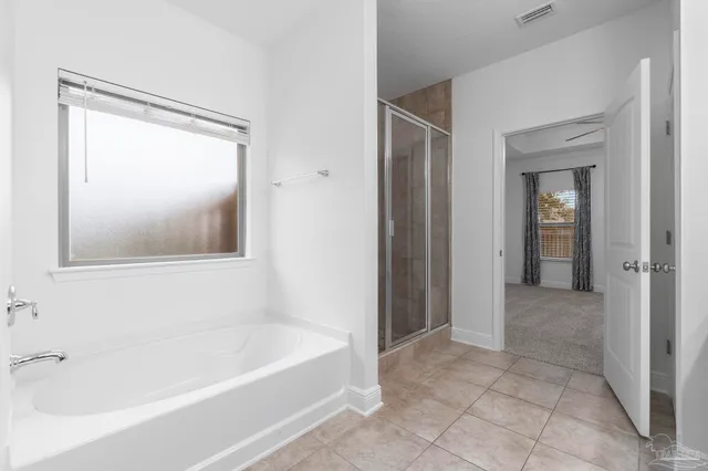 a bathroom with a bathtub and shower