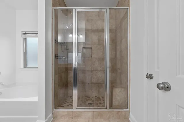 a bathroom with a glass shower door