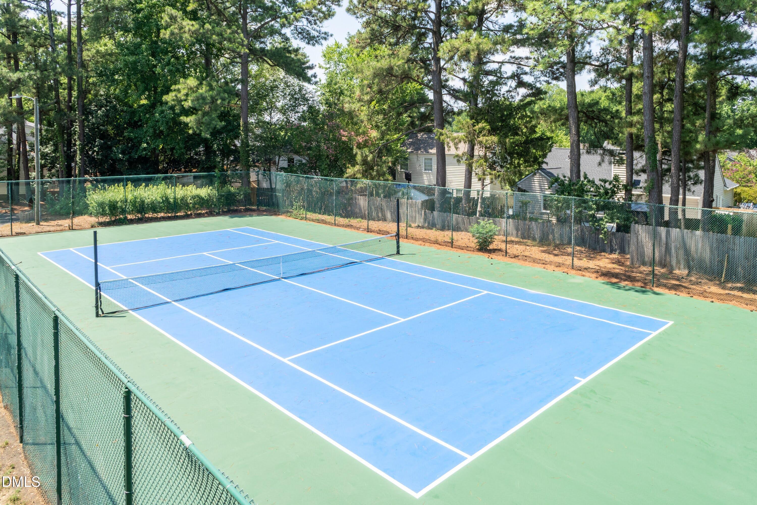 5604 Spring Pines Way Raleigh, NC 27616 - Photo 22 of 22 a tennis court with trees in the background