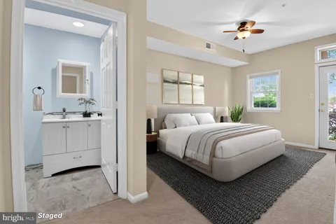 a bedroom with a large bed mirror and a window