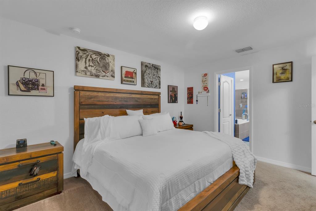 205 Arbuthnot Street Winter Haven, FL 33881 - Photo 15 of 31 a bedroom with a bed and a desk