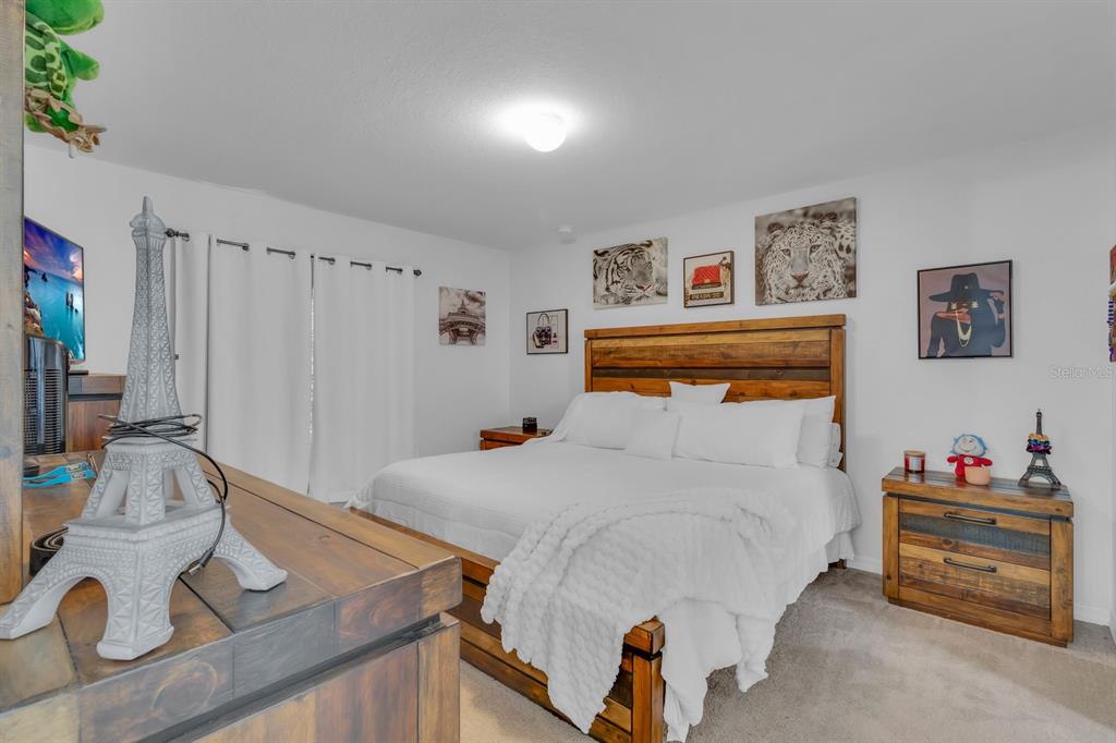 205 Arbuthnot Street Winter Haven, FL 33881 - Photo 16 of 31 a bedroom with a bed and a table in it