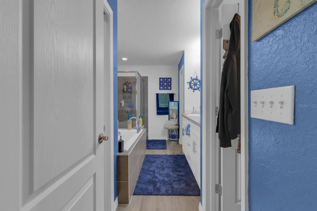 205 Arbuthnot Street Winter Haven, FL 33881 - Photo 19 of 31 a view of a hallway with a livingroom and a hall with wooden floor