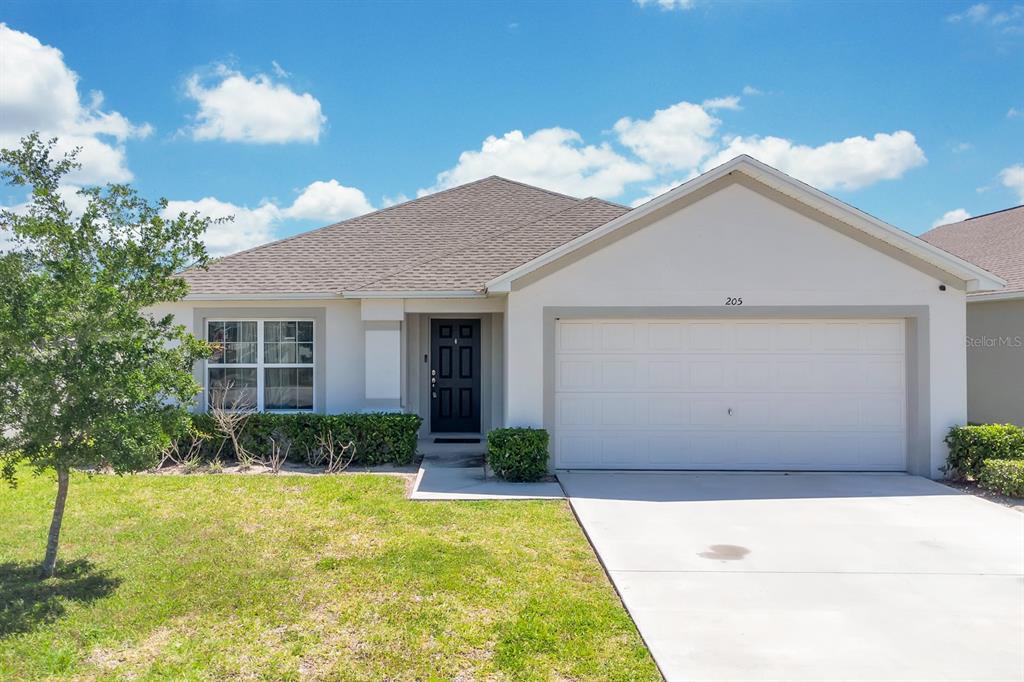 205 Arbuthnot Street Winter Haven, FL 33881 - Photo 2 of 31 a front view of a house with garden