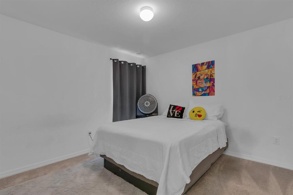 205 Arbuthnot Street Winter Haven, FL 33881 - Photo 21 of 31 a bedroom with a bed and painting on the wall