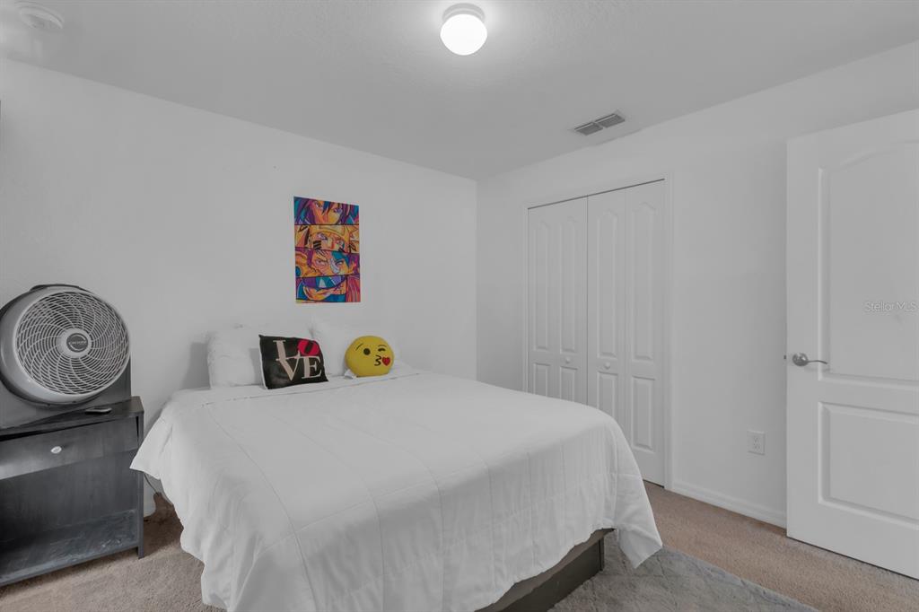 205 Arbuthnot Street Winter Haven, FL 33881 - Photo 22 of 31 a bedroom with a bed and a window