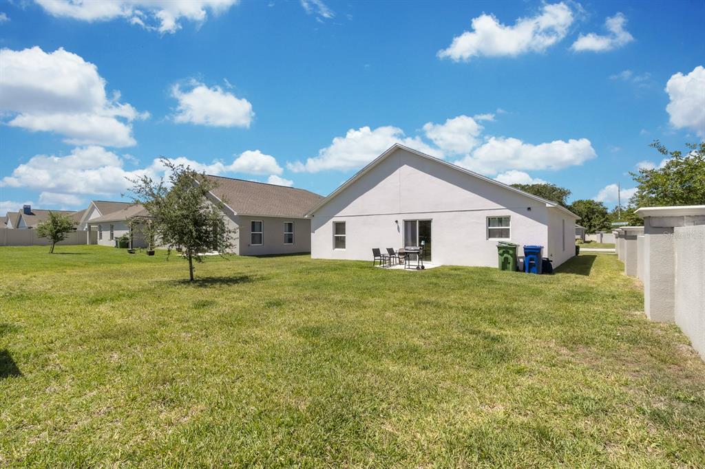 205 Arbuthnot Street Winter Haven, FL 33881 - Photo 27 of 31 a yellow house with trees in the background
