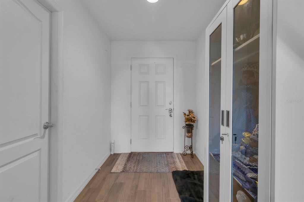 205 Arbuthnot Street Winter Haven, FL 33881 - Photo 7 of 31 a view of a hallway with wooden floor and closet