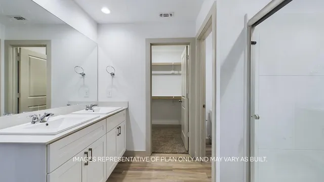 a bathroom with a double vanity sink and mirror