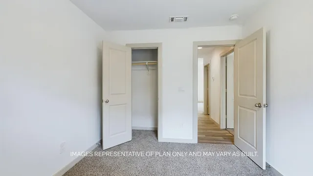 a view of a hallway with wooden floor and entryway