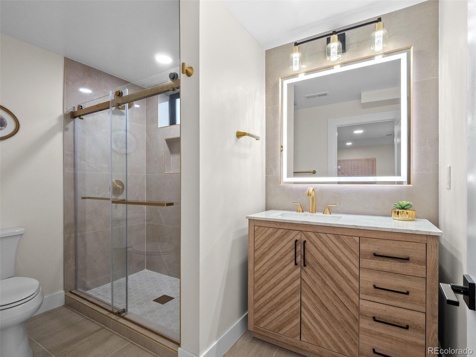 3490 Emerson Avenue Boulder, CO 80305 - Photo 25 of 31 a bathroom with a sink a toilet and shower