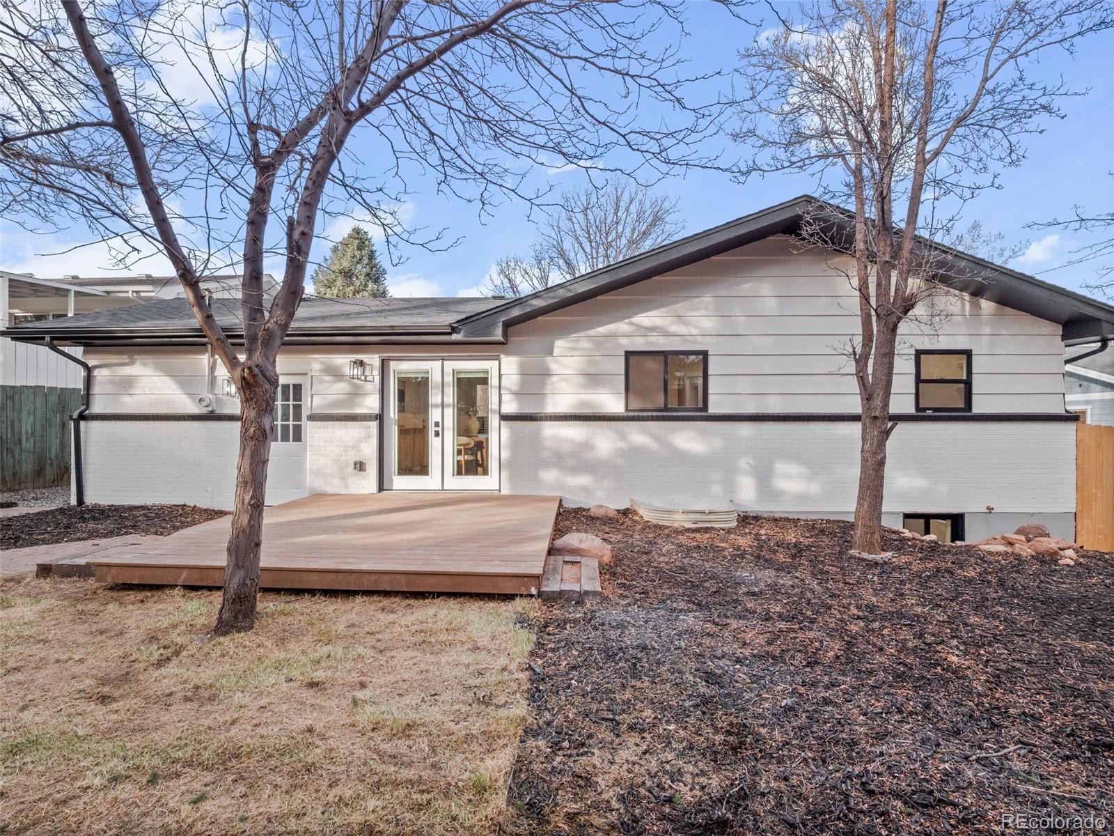 3490 Emerson Avenue Boulder, CO 80305 - Photo 28 of 31 a backyard of a house with wooden fence and large tree