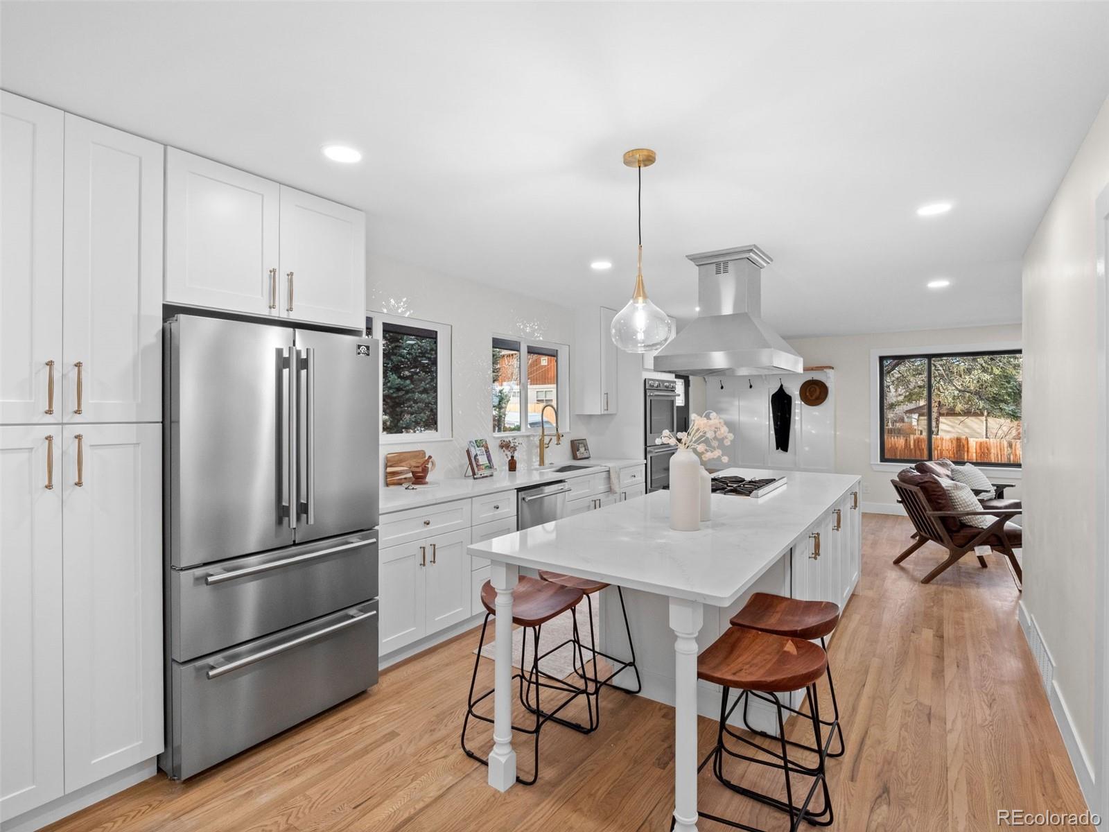 3490 Emerson Avenue Boulder, CO 80305 - Photo 7 of 31 a kitchen with stainless steel appliances a refrigerator a table and chairs