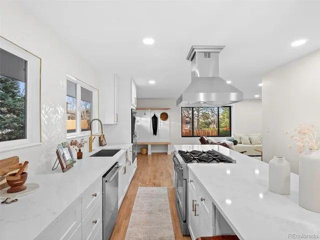 a large white kitchen with a large window