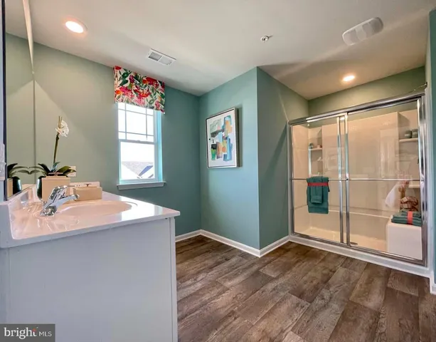 a view of a kitchen with a sink and a mirror