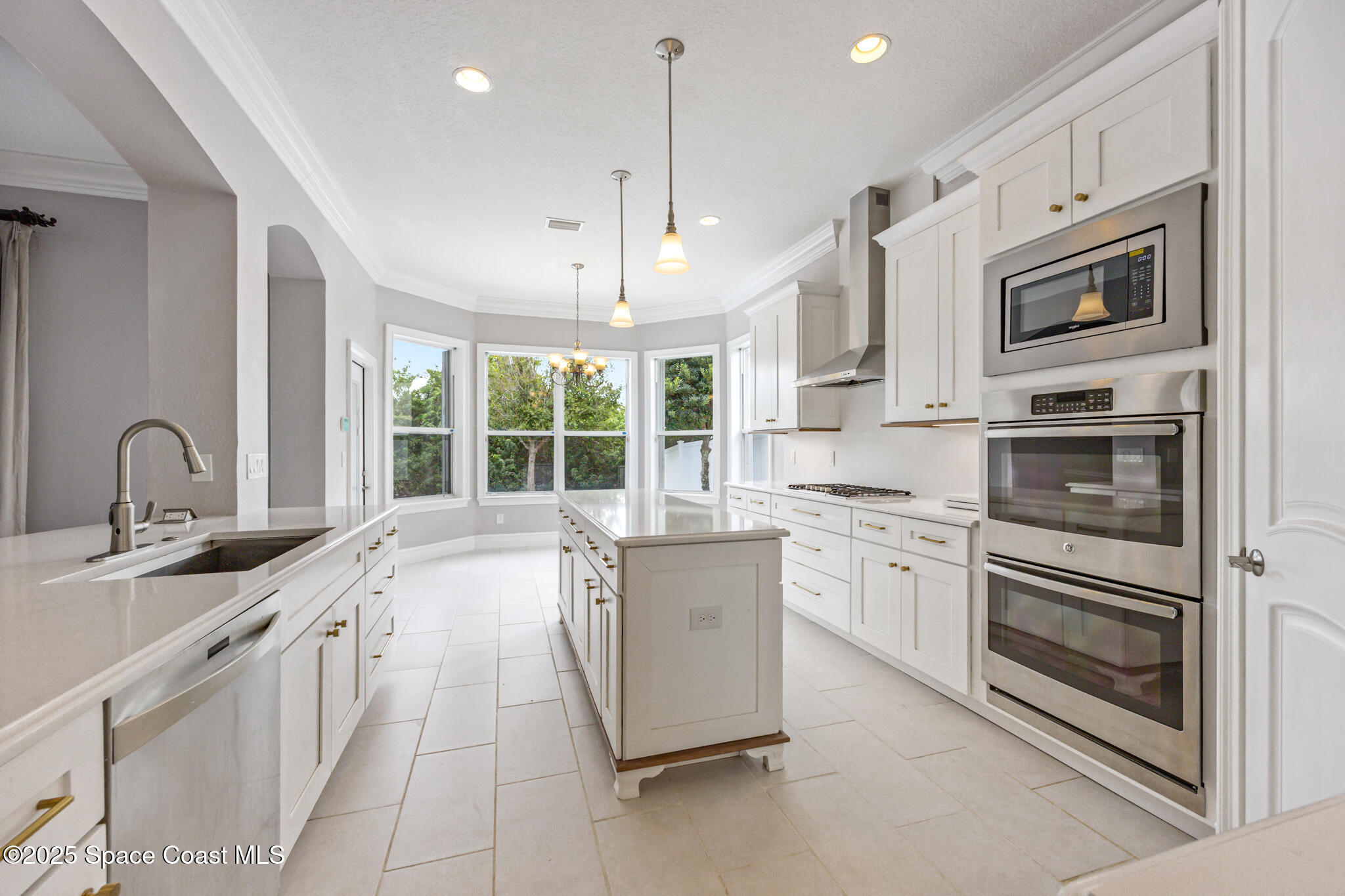 3326 Peninsula Circle Melbourne, FL 32940 - Photo 11 of 53 a kitchen with stainless steel appliances granite countertop a stove and a sink
