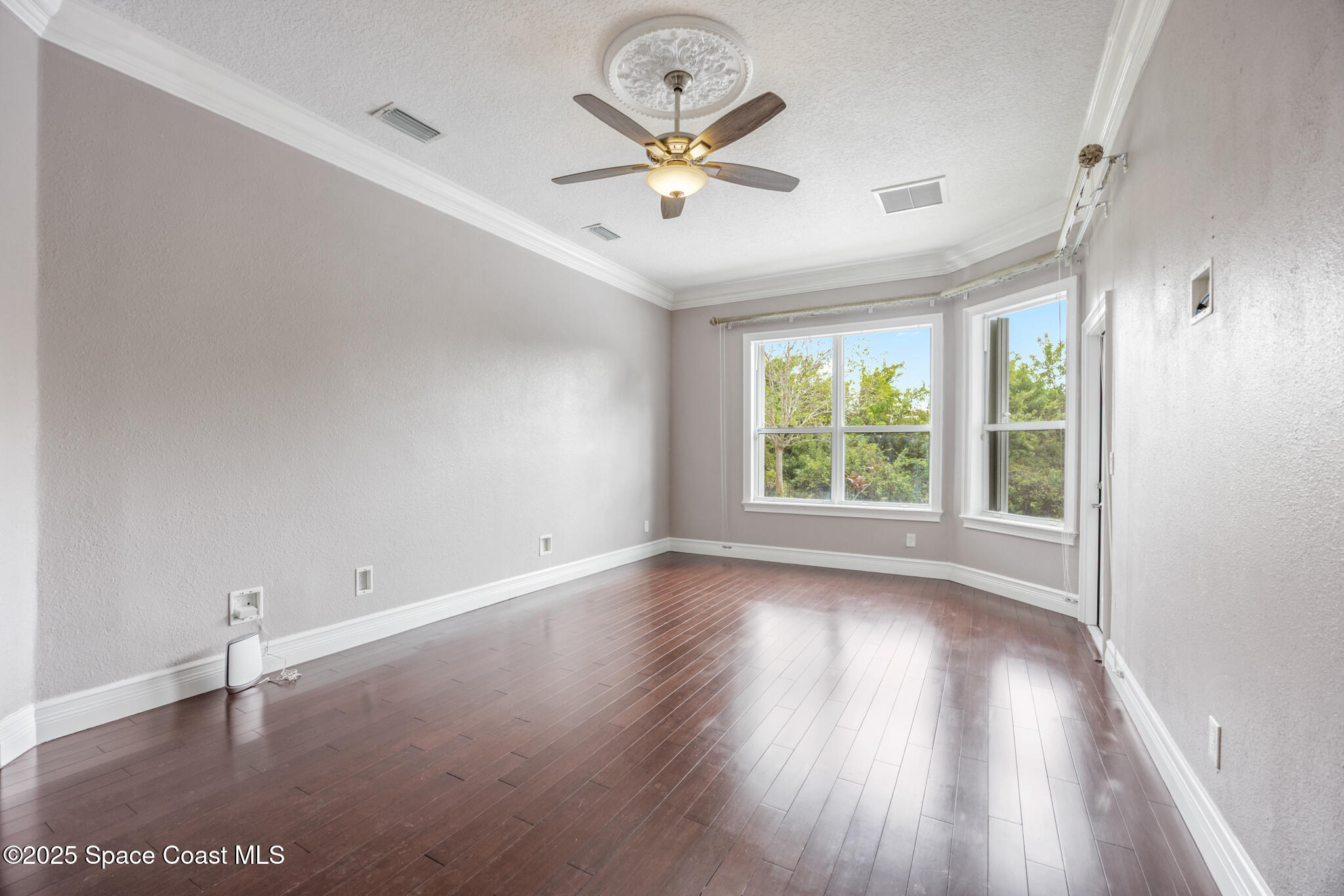 3326 Peninsula Circle Melbourne, FL 32940 - Photo 15 of 53 an empty room with wooden floor and windows