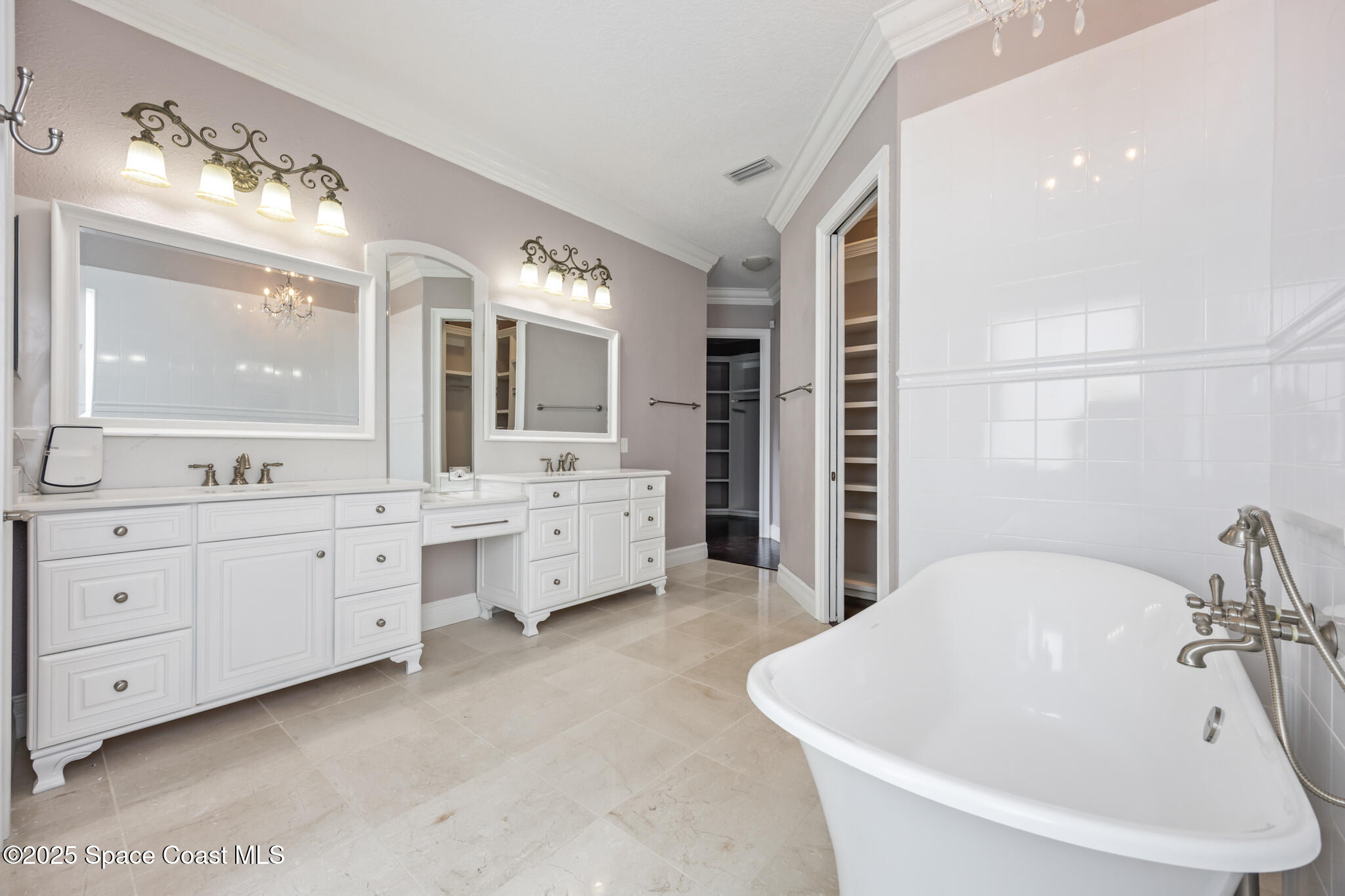 3326 Peninsula Circle Melbourne, FL 32940 - Photo 19 of 53 a spacious bathroom with double vanity sinks a large mirror and a bathtub