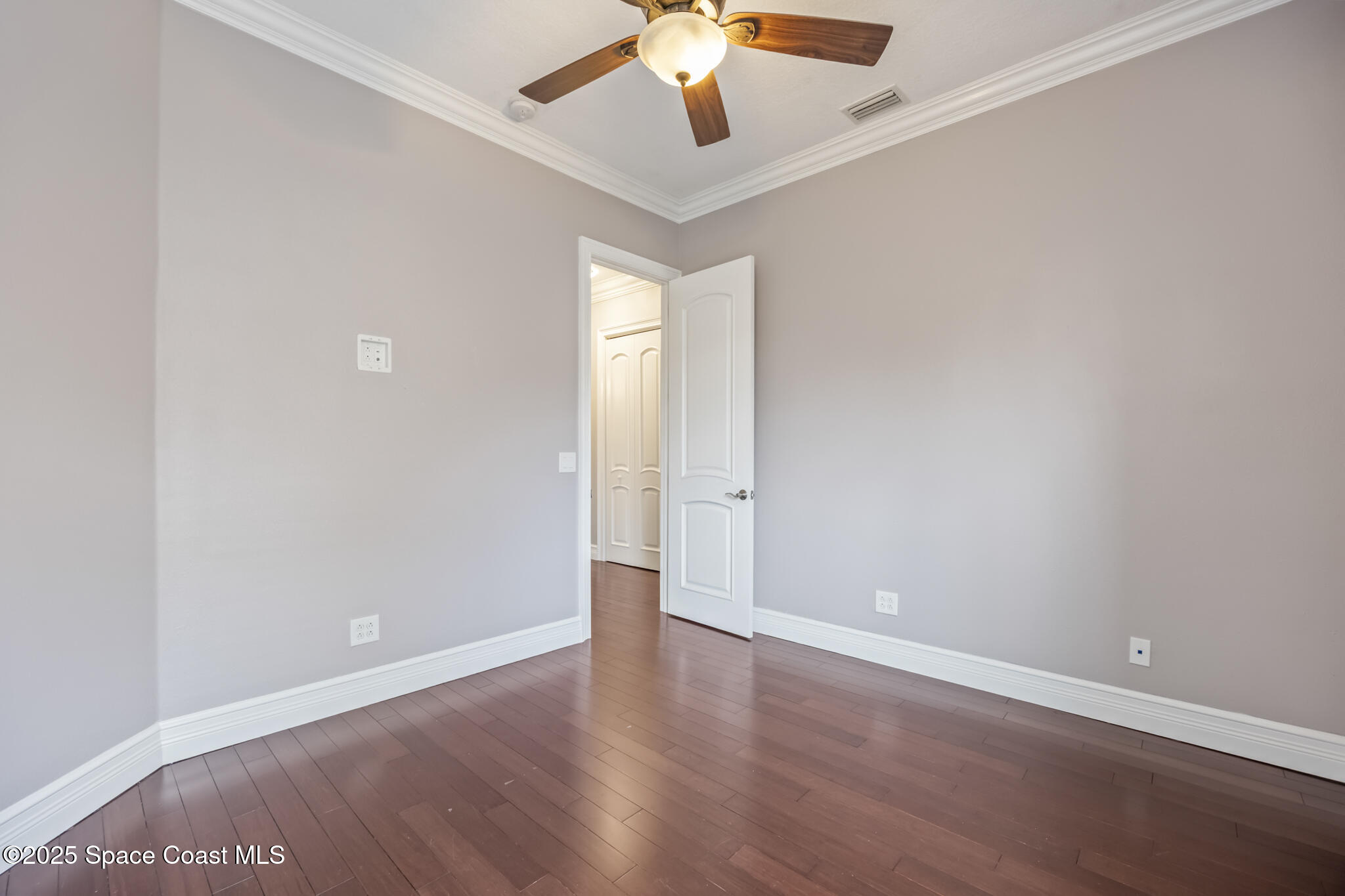 3326 Peninsula Circle Melbourne, FL 32940 - Photo 27 of 53 a view of an empty room with window and wooden floor
