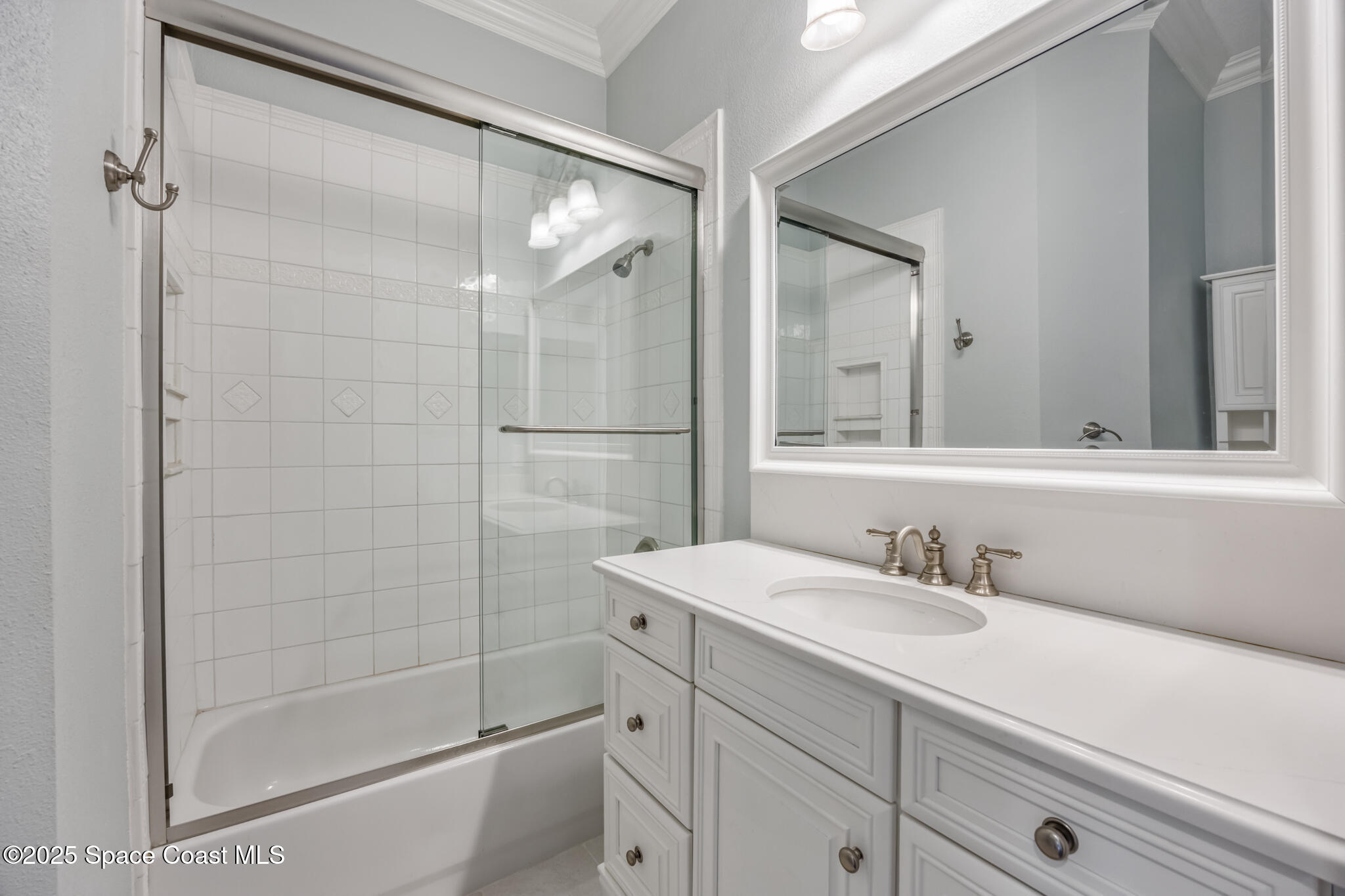 3326 Peninsula Circle Melbourne, FL 32940 - Photo 32 of 53 a bathroom with a shower sink and mirror