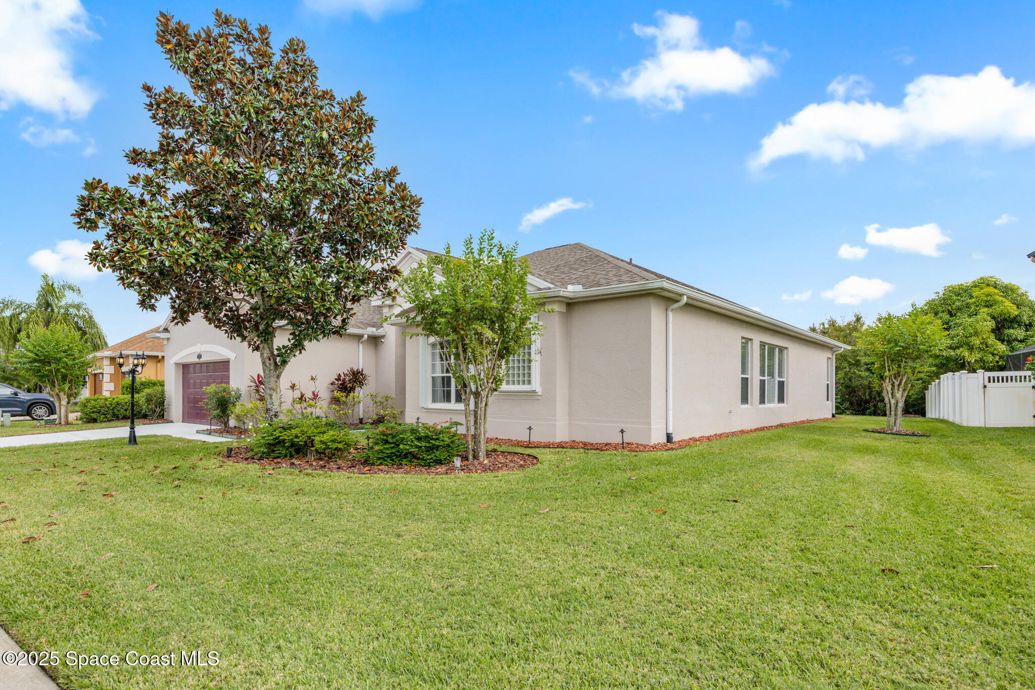3326 Peninsula Circle Melbourne, FL 32940 - Photo 33 of 53 a white house that has a tree in front of it