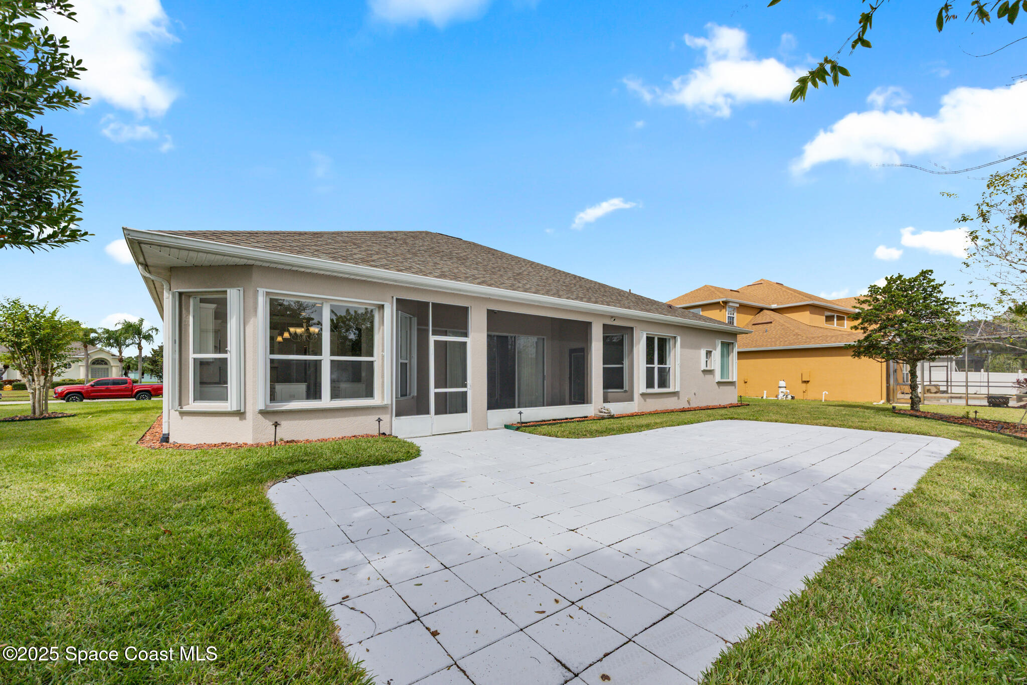 3326 Peninsula Circle Melbourne, FL 32940 - Photo 36 of 53 a front view of a house with a yard and potted plants