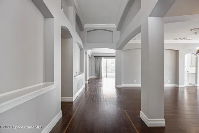 a view of a hallway with wooden floor and staircase