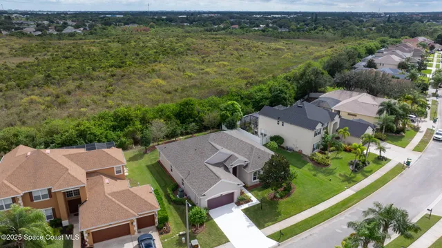 an aerial view of a house with a lake view