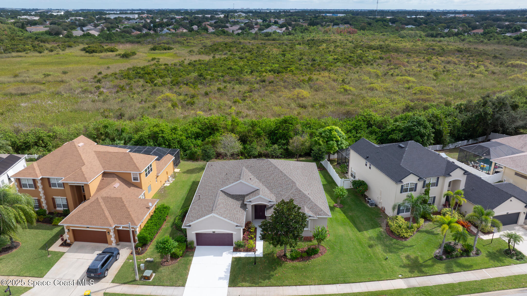 3326 Peninsula Circle Melbourne, FL 32940 - Photo 43 of 53 an aerial view of residential houses with outdoor space and trees