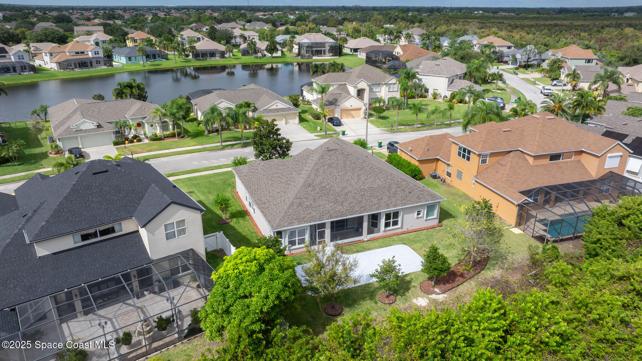 3326 Peninsula Circle Melbourne, FL 32940 - Photo 45 of 53 an aerial view of a house with a lake view