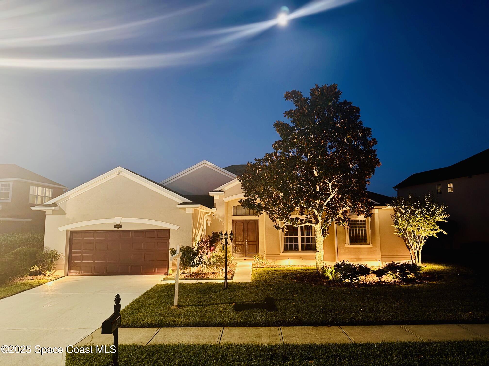 3326 Peninsula Circle Melbourne, FL 32940 - Photo 48 of 53 a front view of a house with a garden