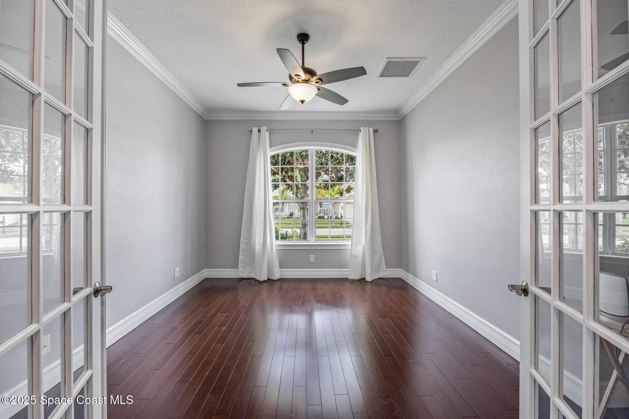 3326 Peninsula Circle Melbourne, FL 32940 - Photo 7 of 53 wooden floor in an empty room with a window