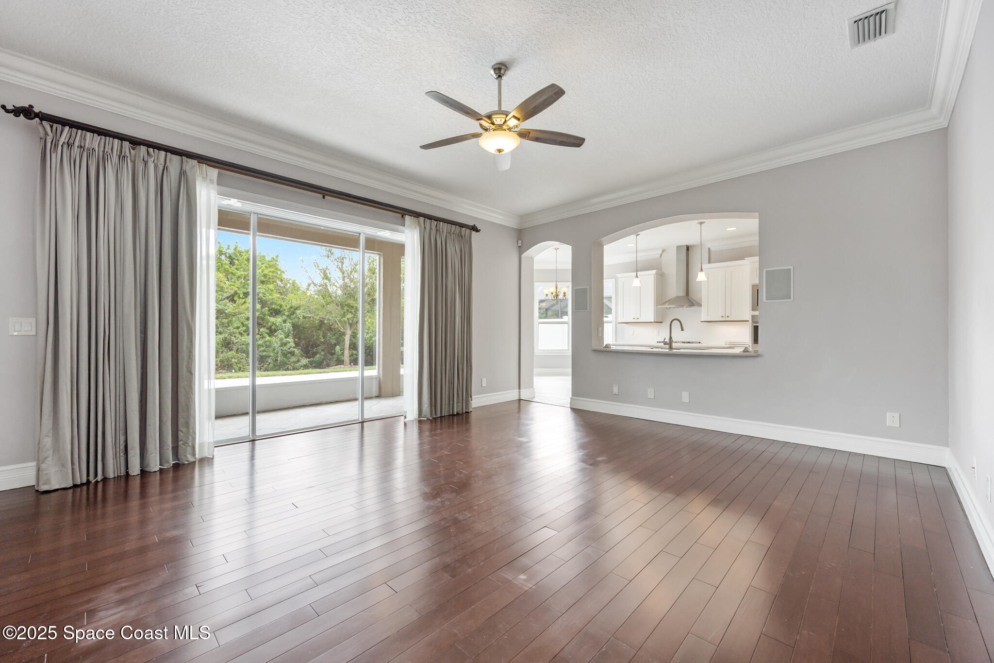 3326 Peninsula Circle Melbourne, FL 32940 - Photo 9 of 53 a view of an empty room with wooden floor and a window