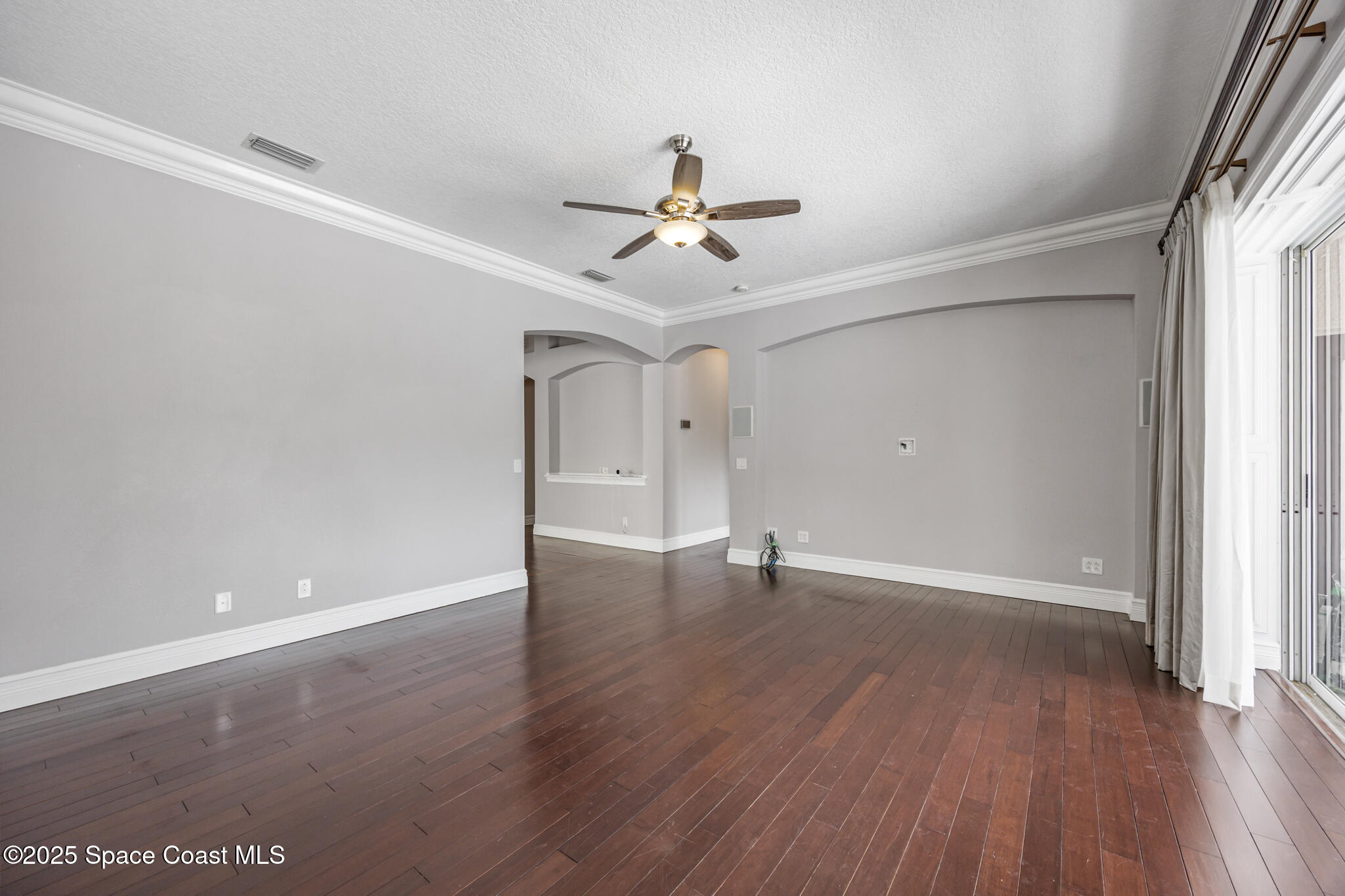 3326 Peninsula Circle Melbourne, FL 32940 - Photo 10 of 53 wooden floor in an empty room with a window