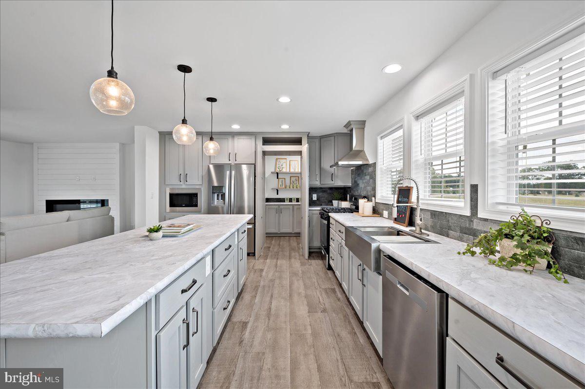 3983 Hastings Road Walnutport, PA 18088 - Photo 13 of 51 a large kitchen with kitchen island a large counter space a sink appliances and a large window