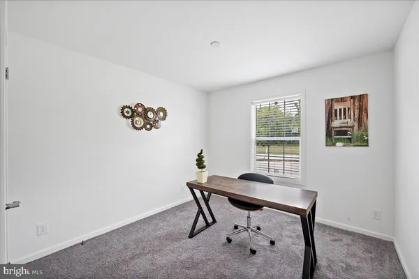 a view of a room that has a table and chair in it