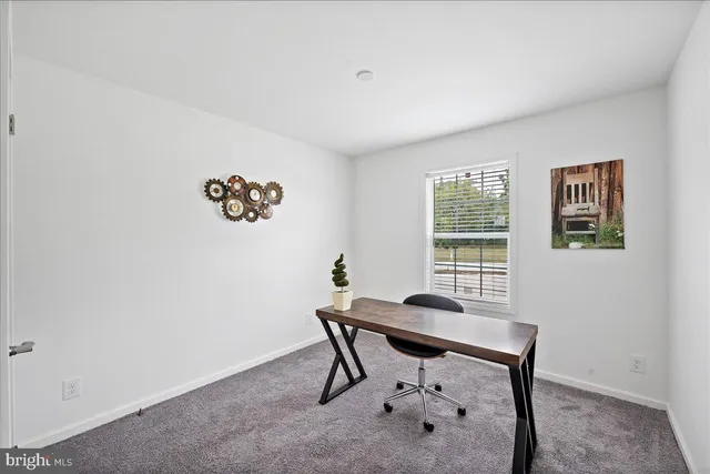a view of a room that has a table and chair in it