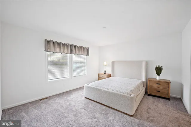 a bed sitting in a bedroom next to a window