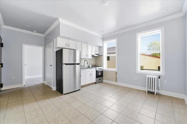 a kitchen with a refrigerator and a sink