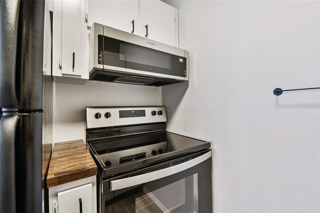 2480 Enterprise Road, Unit 6 Clearwater, FL 33763 - Photo 11 of 43 a stove top oven sitting inside of a kitchen