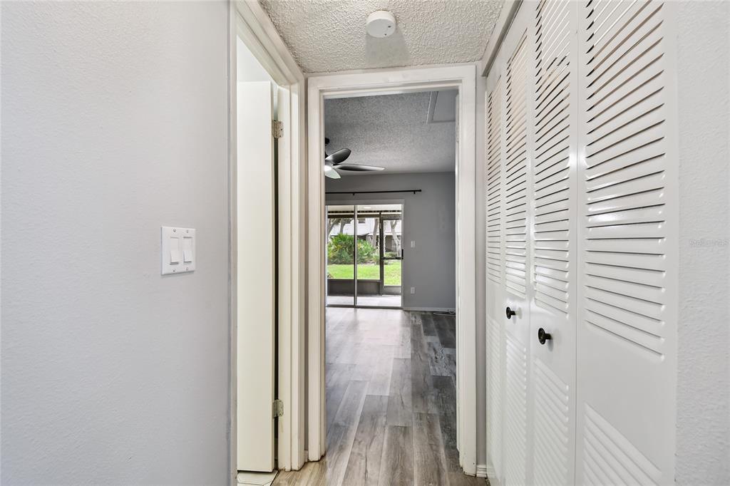 2480 Enterprise Road, Unit 6 Clearwater, FL 33763 - Photo 12 of 43 a view of a hallway with wooden floor and a bathroom