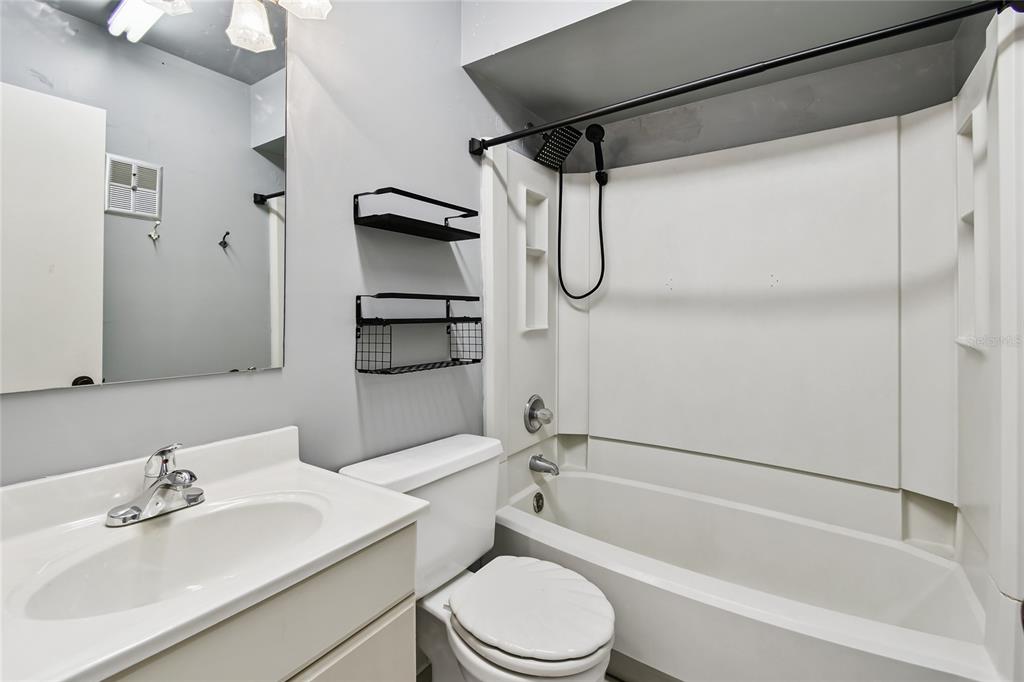2480 Enterprise Road, Unit 6 Clearwater, FL 33763 - Photo 13 of 43 a bathroom with a sink toilet and shower